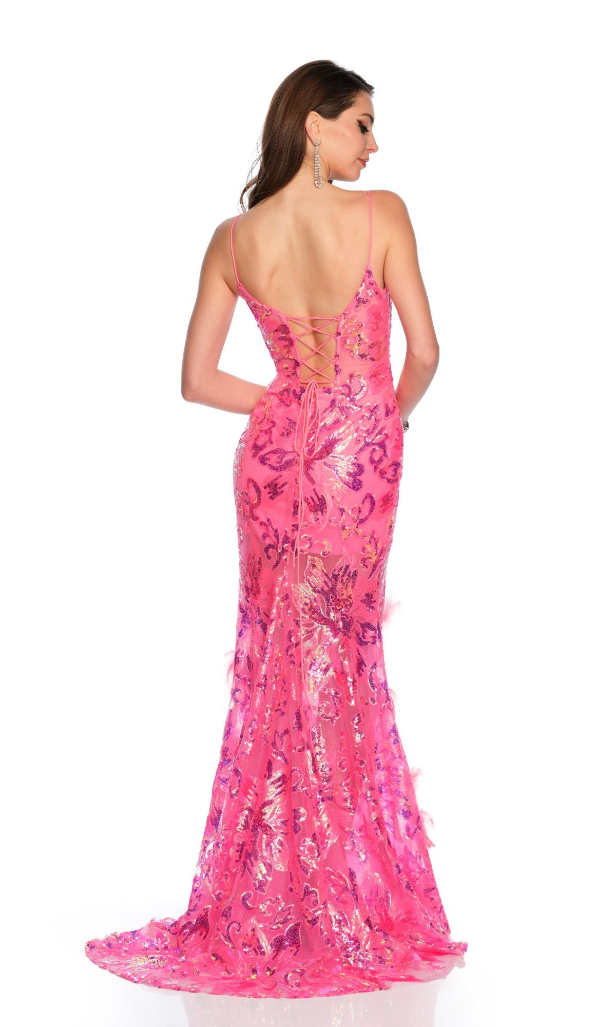 A woman stands facing away from the camera in the Long Formal Dress 11388 by Dave and Johnny, a fitted fuchsia pink gown with sparkling sequins and lace-up back detail.